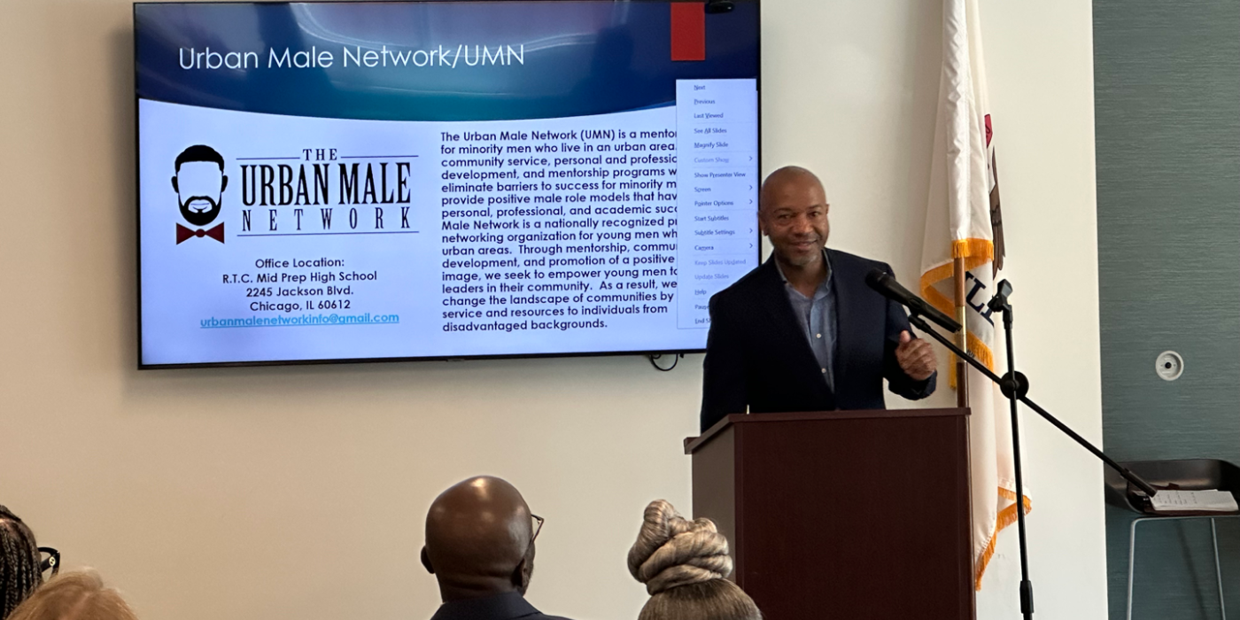 Man talking in front of a crowd